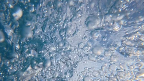 Underwater bubbles swirling inside breaking ocean wave near surface Stock Footage 342159318