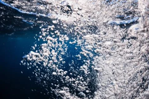 Underwater bubbles texture in transparent ocean. Air bubbles in tropical sea Stock Photos
