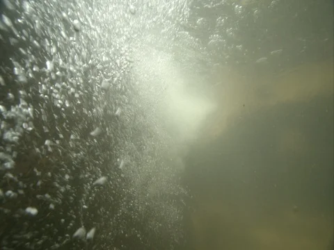Underwater bubbles turbulence in river in slow motion Stock Footage