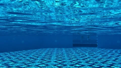 Underwater camera captures mesmerizing sunlight patterns in the pool, with ra Stock Footage 325649552
