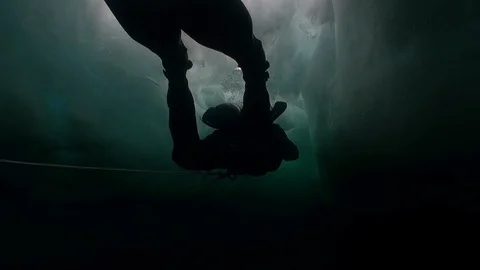 Underwater cameraman with camera and technical diver under ice of lake Baikal. Stock-Footage 118629271