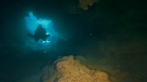 Underwater Cave Diver Scuba Diving In Underwater Sea Cave or Cavern In Deep Blue Video stock 113574580