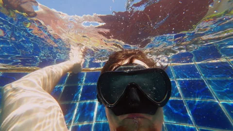 Underwater Close Up Of Man With Diving Mask Blowing Air Bubbles Against Tiled Po Stock Footage 332301182