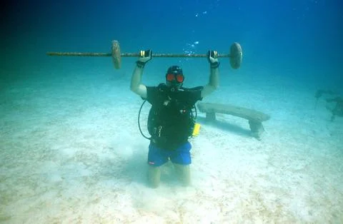 Underwater diver training with weights on a Caribbean coral reef Stock Photos