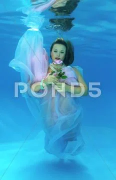 Underwater fashion in the pool Stock Photos