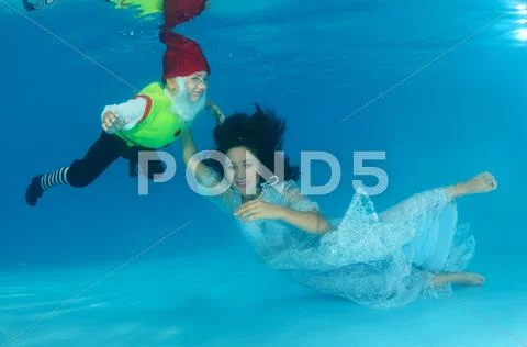 Underwater fashion in the pool Stock Photos