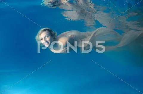 Underwater fashion in the pool Stock Photos