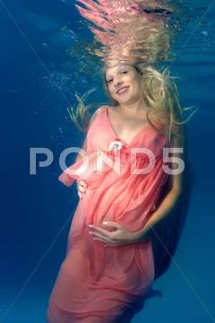 Underwater fashion in the pool Stock Photos