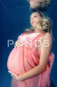 Underwater fashion in the pool Stock Photos