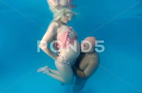 Underwater fashion in the pool Stock Photos
