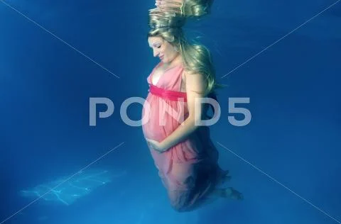 Underwater fashion in the pool Stock Photos