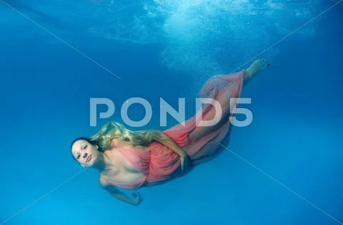 Underwater fashion in the pool Stock Photos