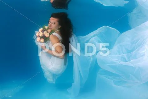 Underwater fashion in the pool Stock Photos