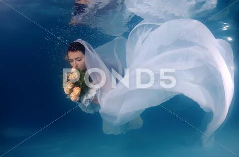 Underwater fashion in the pool Stock Photos