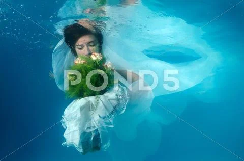 Underwater fashion in the pool Stock Photos
