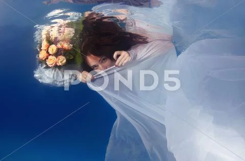 Underwater fashion in the pool Stock Photos