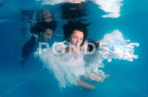 Underwater fashion in the pool Stock Photos
