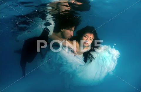 Underwater fashion in the pool Stock Photos