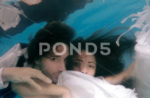 Underwater fashion in the pool Stock Photos
