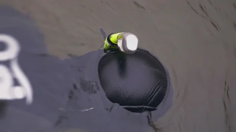 Underwater hunter shines a lantern under the water during spearfishing Stock Footage 104529221