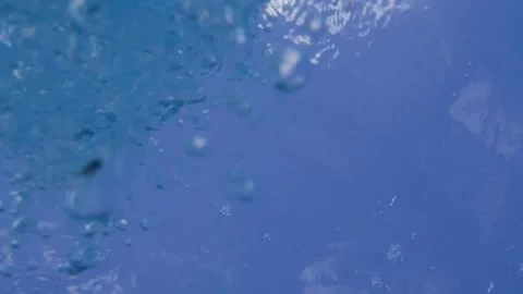 Underwater looking up at blue-sky waves and bubbles Stock Footage 246391660