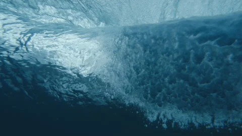 Underwater looking up at an empty wave rolling in slow motion Stock Footage 169058972