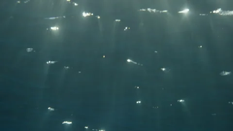 Underwater looking up at the surface as sunrays shimmer from above Stock Footage 169051835