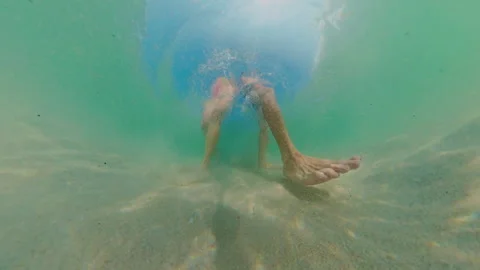 Underwater Low Angle View Couple Walking On Sandy Bottom With Strong Bubble Spla Stock Footage 333290905