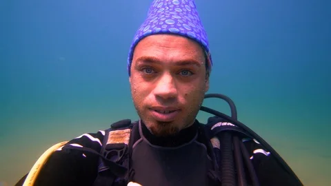 Underwater a man is looking to the camera Stock Footage 116486479