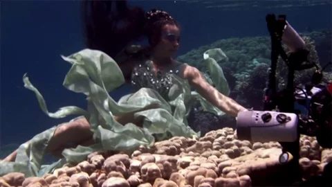 Underwater model free diver poses for camera on background of corals in Red Sea. Video stock 73297811