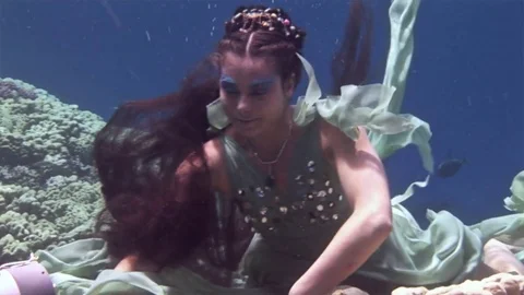 Underwater model free diver poses for camera on background of corals in Red Sea. Video stock 73297859