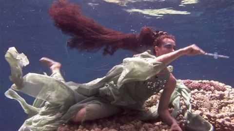 Underwater model free diver poses for camera on background of corals in Red Sea. Video stock 73298014
