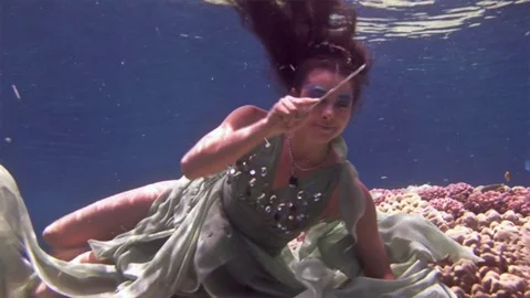 Underwater model free diver poses for camera on background of corals in Red Sea. Video stock 73298116