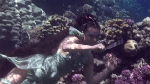 Underwater model free diver poses for camera on background of corals in Red Sea. Video stock 73298386