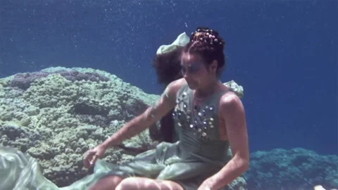 Underwater model free diver poses for camera on background of corals in Red Sea. Video stock 73413299