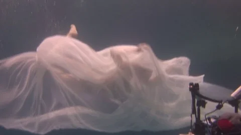 Underwater model young girl free diver in white transparent veil in Red Sea. Stock Footage