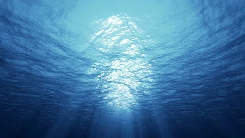 Underwater ocean waves deep blue ripple and flow with light rays. 4K seamless Stock Footage 132456980