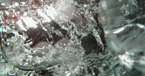 Underwater perspective of ice cubes falling into fresh water with bubbles a.. Stock Footage 337467600