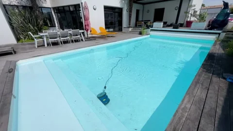 Underwater pool vacuum cleaner in a private house with bioclimatic pergola Stock Footage 244548435