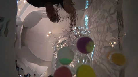 Underwater POV shows four bath bombs simultaneously dropped into bathwater Stock Footage 335785524