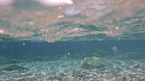 Underwater river flowing on pebbles and rocks. Stock Footage 332702209