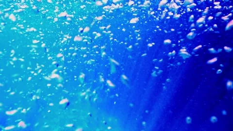 Underwater scene of deep blue ocean with bubbles and sunlight, slow motion Stock Footage 279430899