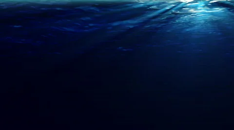 Underwater scene with sunrays shining through the water's surface. (High Def) Stock Footage