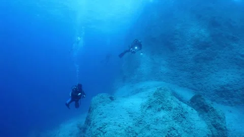 Underwater scenery of scuba divers  exploring underwater with some fish around Stock Footage 330967554