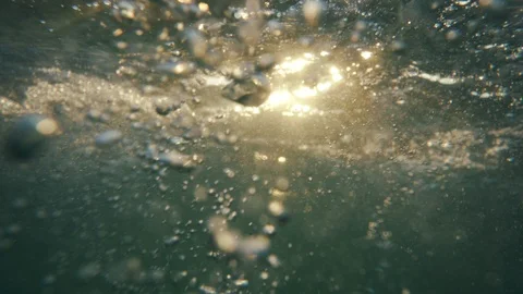 Underwater, sea waves with sunrays shining through the water Stock Footage 114785421