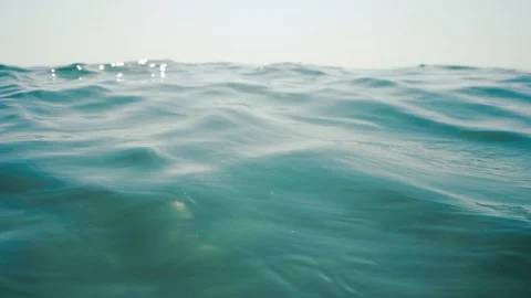 Underwater, sea waves with sunrays shining through the water Stock Footage 114791475