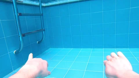Underwater sequence showing hand reaching towards shimmering surface, bubbles Video stock 318588018