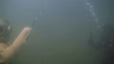 Underwater shooting of a diver in retro diving gear Stock Footage 148592425