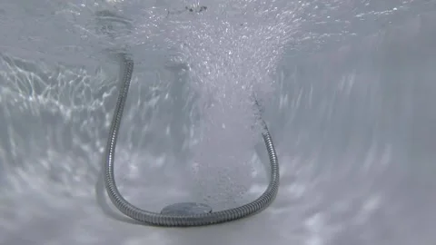 Underwater shooting. dolls fall into the bath. Water is poured into the bath Video stock 130662409