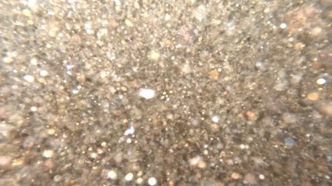Underwater shot abstract background sparkling gold mica sand in sea Stock Footage 248020650